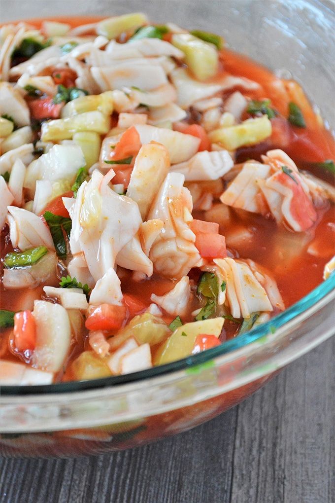 a glass bowl filled with pasta and vegetables