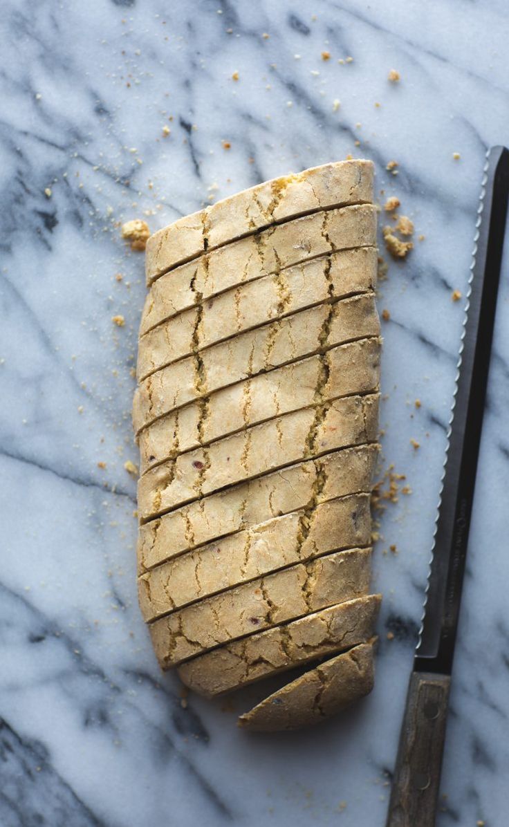 a sliced up pastry sitting on top of a table next to a knife