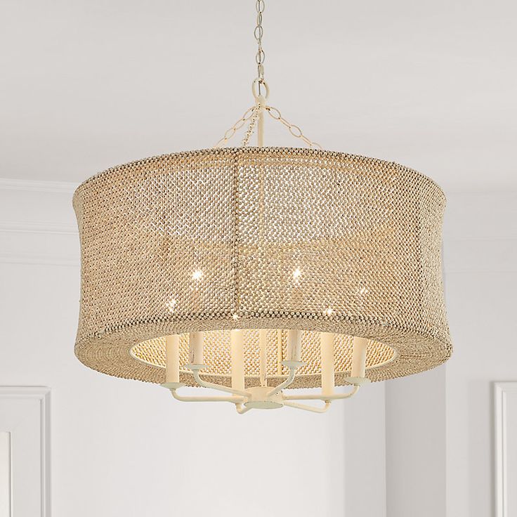 a chandelier hanging from the ceiling in a room with white walls and flooring