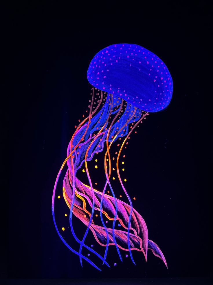 a blue and purple jellyfish floating in the dark