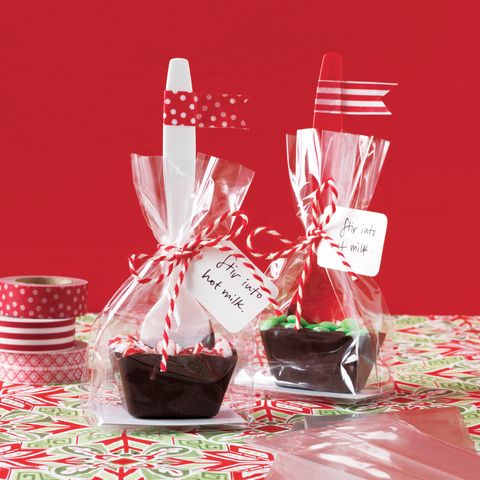 two small cups filled with chocolates on top of a table