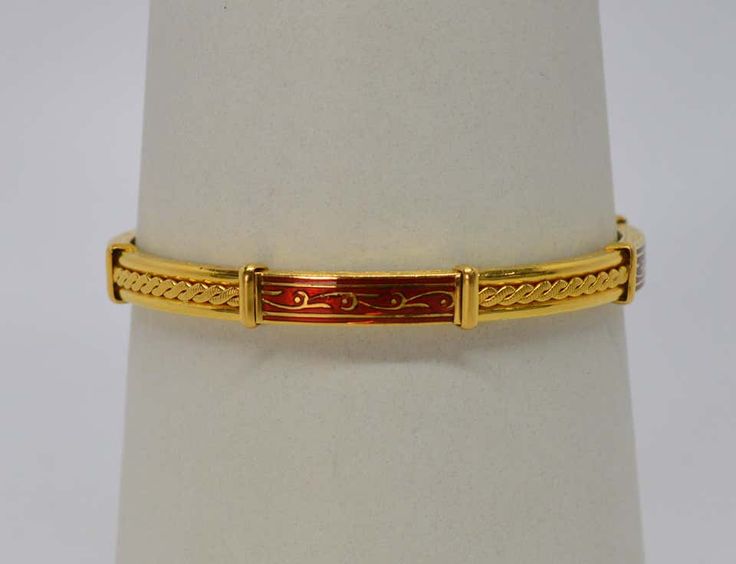 For Sale on 1stDibs - Quality craftsmanship shows in the intricate scroll pattern detail skillfully engraved on the rim and throughout the enamel work. Accented with alternating Luxury Formal Enamel Bracelets, Luxury Enamel Bracelets For Formal Occasions, Gold Meenakari Bracelets For Formal Occasions, Luxury Yellow Gold Enamel Bangle, Elegant Red Gold Bracelet For Formal Occasions, Ceremonial Red Bangle With Intricate Design, Red Ceremonial Bangle With Intricate Design, Formal Byzantine Bracelets With Engraving, Traditional Jewelry With Decorative Band