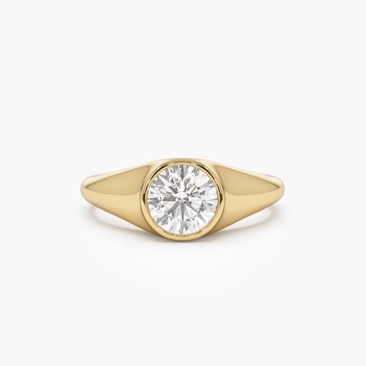 Introducing our 14K Gold Round Cut Lab Grown Diamond Signet Ring, featuring a 1.00 ctw diamond in a sleek bezel setting. This dainty unisex ring is perfect as an engagement or promise ring, offering a modern and refined style. Ideal for stacking, it makes a thoughtful birthday gift that blends elegance with versatility. Expertly crafted, this ring is a timeless addition to any jewelry collection. Every diamond featured in this listing is a "LAB GROWN" diamond. Features * Made to Order. * Gold KT: 14K (18K and Platinum Available upon Request) * Custom Gold Color: Rose Gold, Yellow Gold, White Gold * Width: 7.5 MM Graduates Down to 2.4 MM * Height: 4 MM * Round Shaped Lab Grown Diamonds: 1 Pc 6.5 MM * Total CTW: 1.00 ctw  * Diamond Color-Clarity: E-F Color VS Clarity ▶ Want to find out more? Diamond Signet Pinky Ring, Classic 14k Gold Wedding Ring With Bezel Setting, Moissanite Yellow Gold Rings With Bezel Setting, Diamond Bezel Setting Signet Ring, 14k Gold Signet Ring With Bezel Setting, 14k Gold Signet Ring With Brilliant Cut, White Gold Diamond Signet Ring With Bezel Setting, Classic 14k Gold Ring With Bezel Setting, Fine Jewelry Signet Ring With Brilliant Round Cut