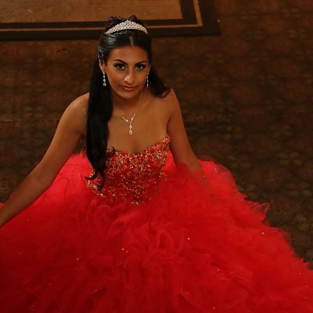 a woman in a red dress posing for the camera