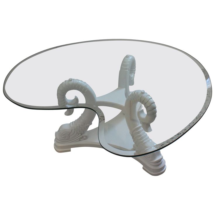 a glass and metal coffee table with an animal head on it's base, viewed from the top