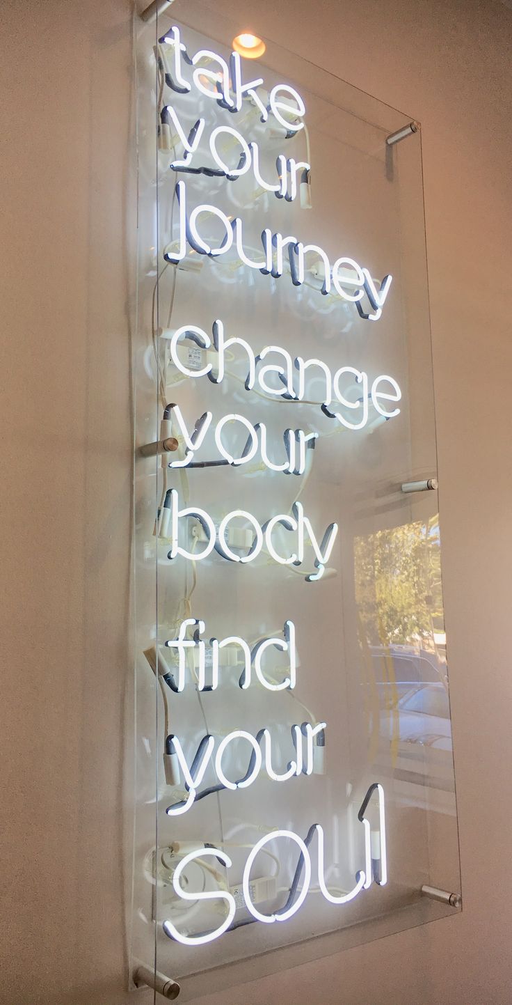 a neon sign that says take your journey change your body find your soul on the wall