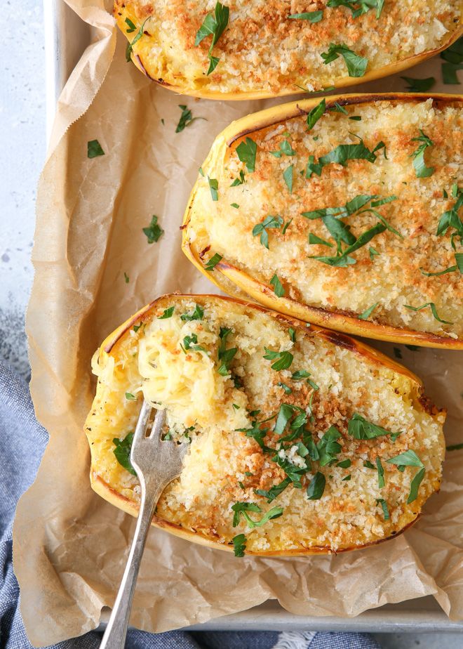 baked stuffed squash with parmesan cheese and fresh herbs on top, ready to be eaten