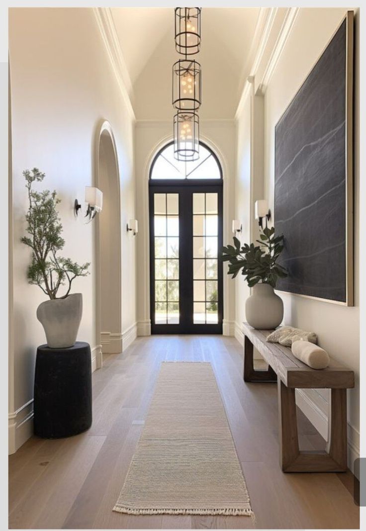 an entry way with a rug and vases on the floor