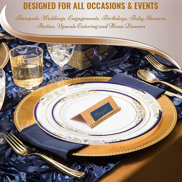 a table set for an event with gold and blue plates, napkins, silverware, and wine glasses