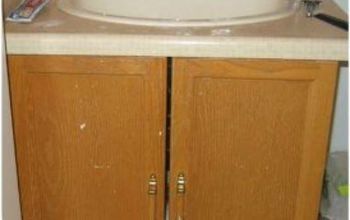 a bathroom with a sink and wooden cabinets