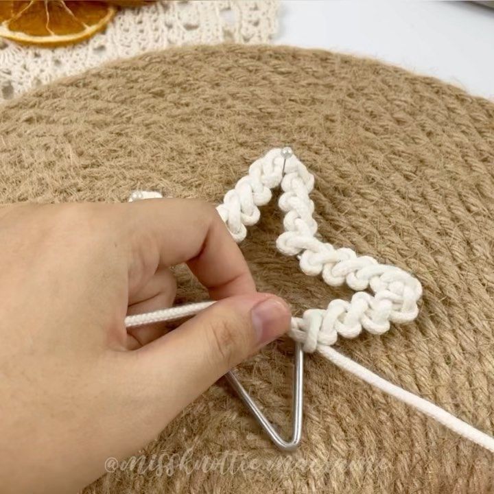 someone is crocheting an object with yarn