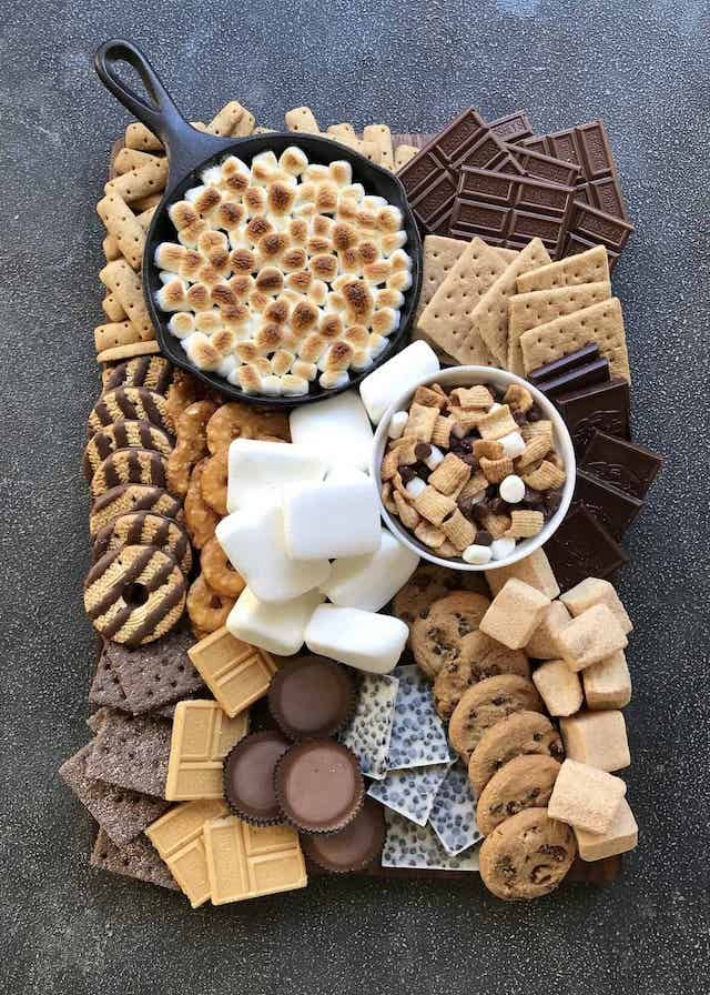 a platter filled with lots of different types of desserts and crackers on top of a table