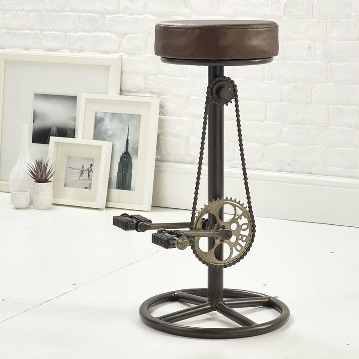 an industrial style stool with a clock on it's back and wheels attached to the seat