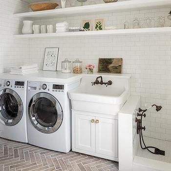 there is a washer and dryer in this small laundry room with open shelving