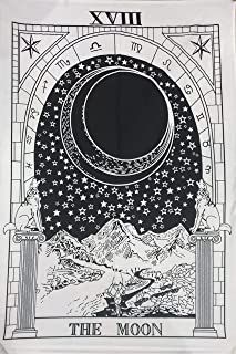 the moon tarot card with mountains in the background