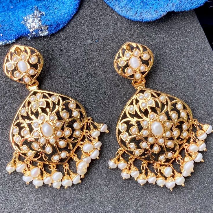 Discover the timeless beauty and elegance of pearls with our dainty, antique look pearl earrings. Made with high-quality, genuine freshwater pearls, these earrings add a touch of sophistication to any outfit and occasion. The golden hue of the pearls is accentuated by the intricate antique design, giving them a luxurious and exclusive appeal. With these pearl earrings, you'll radiate an air of refined taste and class. The earrings close with a threaded bombay screw. Ornate White Pearl Drop Earrings, White Intricate Design Pearl Drop Earrings, Gold Pearl Drop Danglers, Exquisite Pearl Drop Earrings, Festive Pearl Drop Dangle Earrings, Luxury Gold Pearl Drop Chandelier Earrings, Gift White Pearl Earrings With Intricate Design, Luxury Gold Pearl Embellished Earrings, Traditional Festive Pearl Earrings With Elegant Design