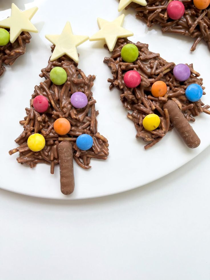 a white plate topped with chocolate christmas trees and m & m candies on top of it