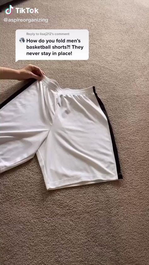 someone is laying on the floor with their shorts in front of them and there is a tweet that says, how do you fold men's basketball shorts?