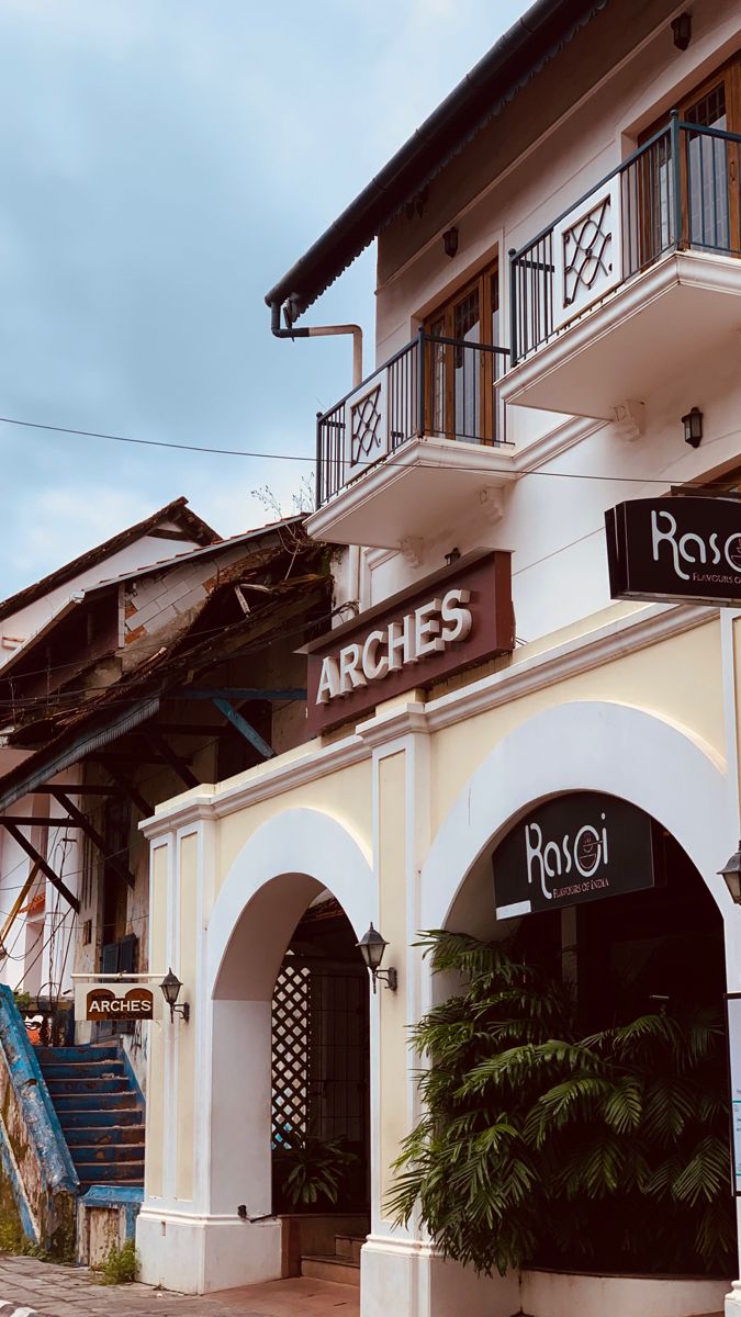 an old building with arches and signs on the front