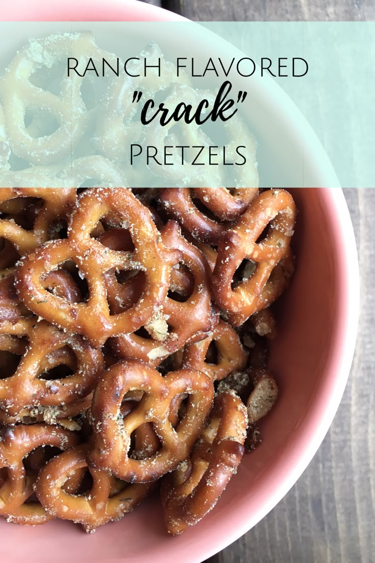 a pink bowl filled with pretzels on top of a wooden table