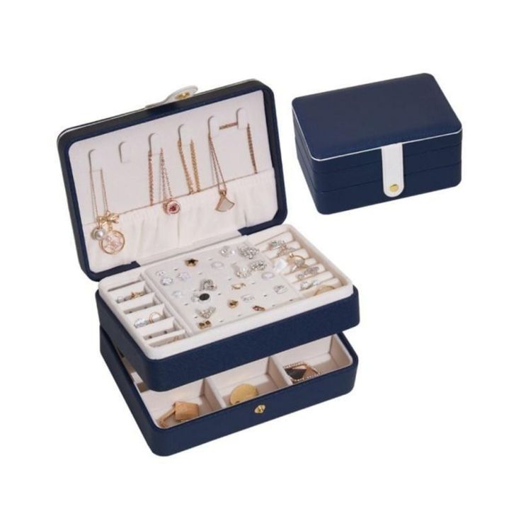 an open blue box with jewelry in it on a white background and the lid opened