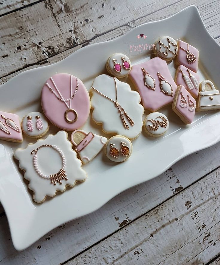 a white plate topped with lots of decorated cookies