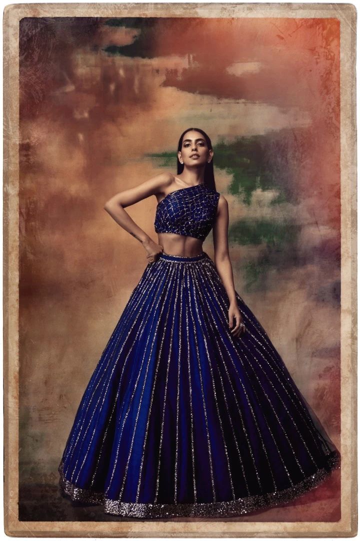 Vvani By Vani Vats | Midnight Blue Lehenga Skirt & Blouse | INDIASPOPUP.COM One Shoulder Lehenga For Reception, Blue Sequined Lehenga For Party, Evening One Shoulder Dress With Zari Work, Glamorous Blue Sequined Lehenga, Evening One-shoulder Dress With Zari Work, One Shoulder Evening Dress With Zari Work, One-shoulder Lehenga For Festive Reception, One-shoulder Festive Lehenga For Reception, Festive One-shoulder Lehenga For Reception