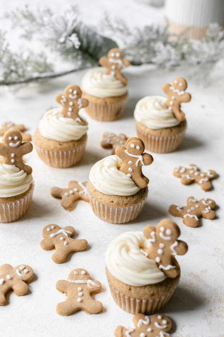 frosted and garnished gingerbread cupcakes with a lot of gingerbread man cookies laying around them Small Batch Gingerbread, Winter Cupcakes, Christmas Cupcakes Decoration, Gingerbread Baby, Xmas Desserts, Gingerbread Cupcakes, Small Batch Baking, Cupcakes With Cream Cheese Frosting, Holiday Cupcakes