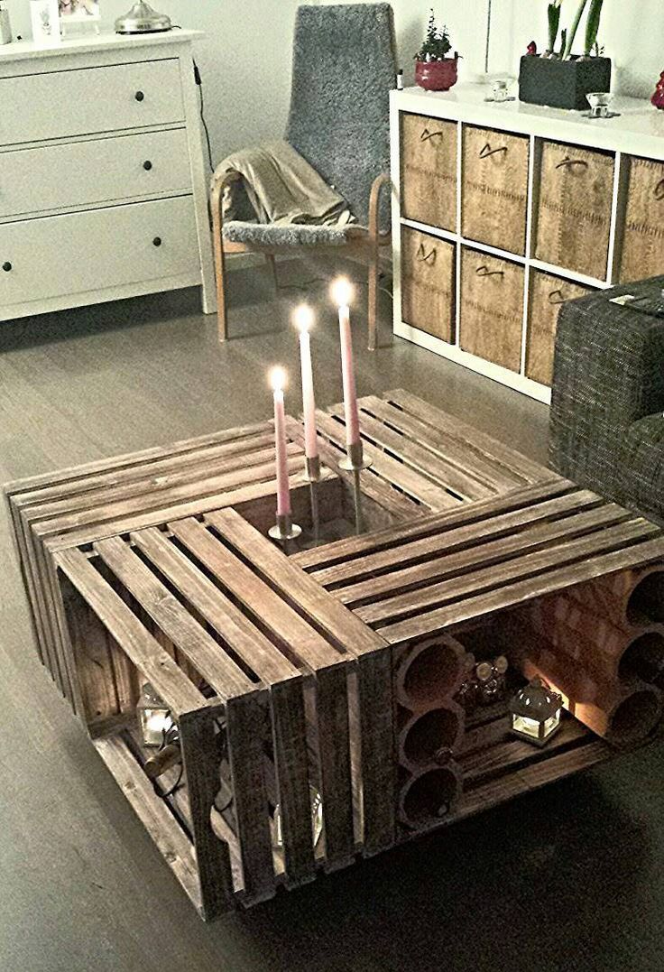 a coffee table made out of pallets with candles