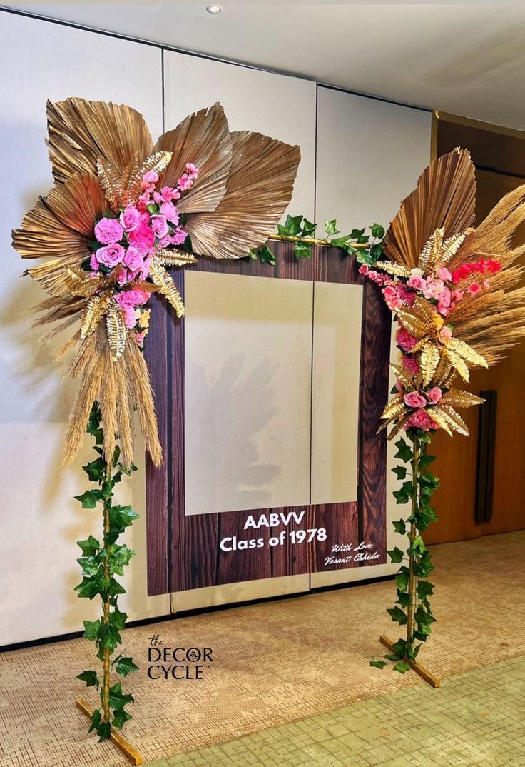 a photo frame decorated with flowers and greenery in front of a wall that says aav classroom 78