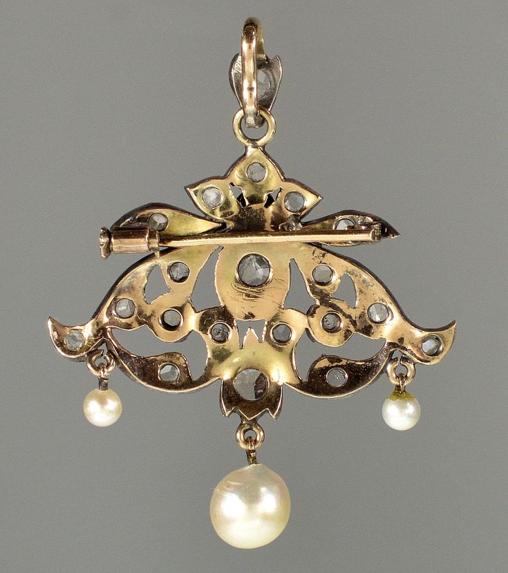 "This pendant is a great example of end of 19th century trend in jewelry. Elaborate design of the pendant incorporates total of 21 rose cut diamonds. The largest diamond, approx 5 mm across, set in crimped bezel mount in the center. The rose cut diamonds radiate a soft glitter under candle light of the ballrooms. Typically for the time the back of the pendant is gold and the front is sterling for better color fit to the diamonds especially with natural silver patina. The pendant would not be com Antique Pendant Brooch With Intricate Design, Antique Brooch With Intricate Pendant Design, Antique Baroque Brooches With 17 Jewels, Antique Gold Brooches With Rose Cut Diamonds, Ornate Gold Brooch With Rose Cut Diamonds, Ornate Gold Brooches With Rose Cut Diamonds, Victorian Gold Pendant Brooches, Victorian Jewelry With Historical Design For Evening, Gold Baroque Jewelry With Rose Cut Diamonds