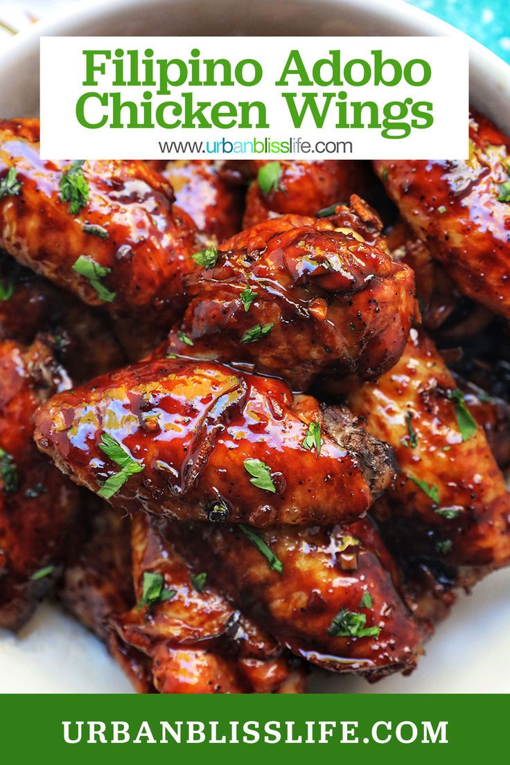 a close up of chicken wings in a bowl with text overlay that reads, philippines adobo chicken wings