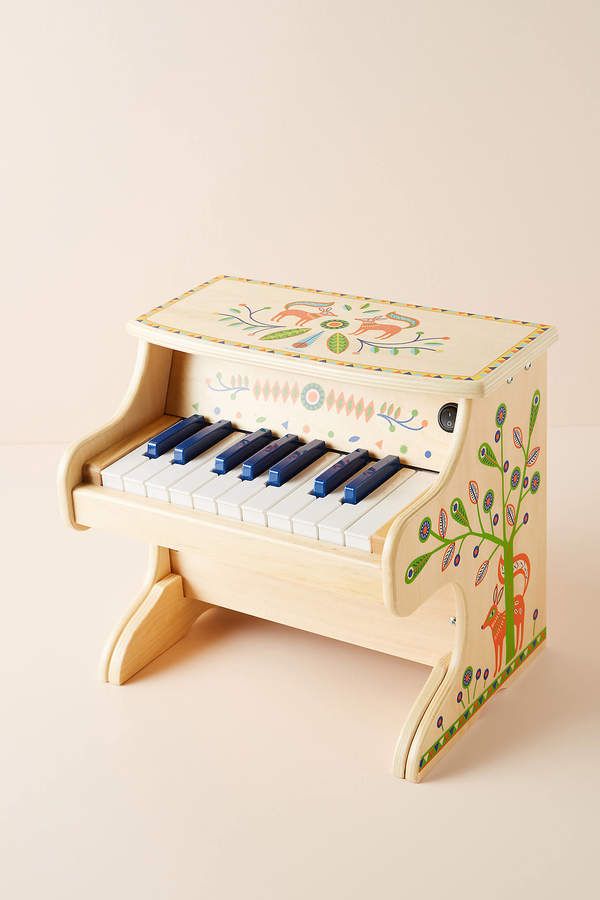 a wooden toy piano sitting on top of a table