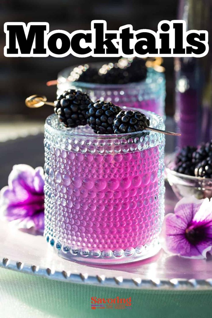 there is a magazine cover with blackberries in the glass jar and flowers on the table