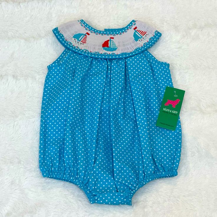 New With Tags Sleeveless Polka Dot Bubble Suit With Sailboat Smocked Yolk. Snap Closure Between Legs. Buttons At Neck. Size 9 Months. Sleeveless Cotton Bubble Romper For Vacation, Fitted Sleeveless Bubble Romper For Vacation, Light Blue Sleeveless Bubble Romper For Spring, Sleeveless Blue Bubble Romper For Playwear, Blue Sleeveless Casual Bubble Romper, Blue Bubble Romper For Summer Playtime, Playful Fitted Blue Bubble Romper, Playful Summer Bubble Romper With Cartoon Print, Playful Cotton Bubble Romper With Smocked Back