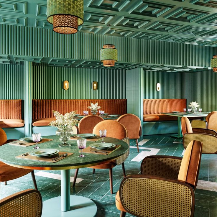 an empty restaurant with green walls and chairs