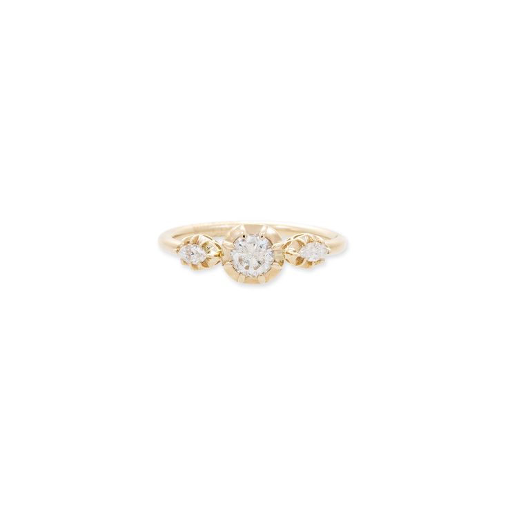 a yellow gold engagement ring with three diamonds