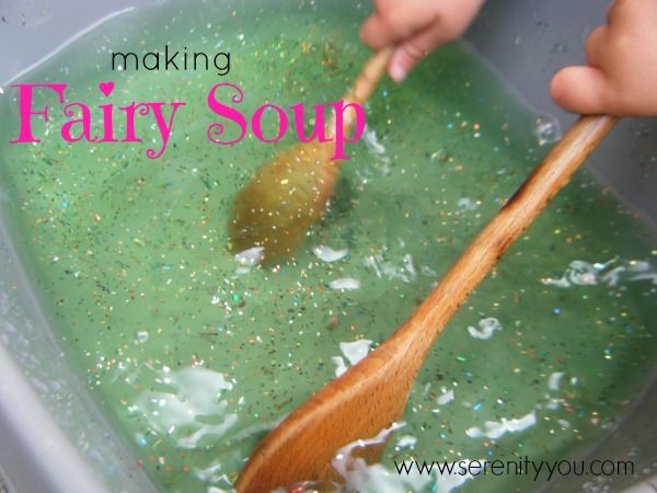 a person mixing green liquid in a bowl with a wooden spoon on the side and words making fairy soup above it