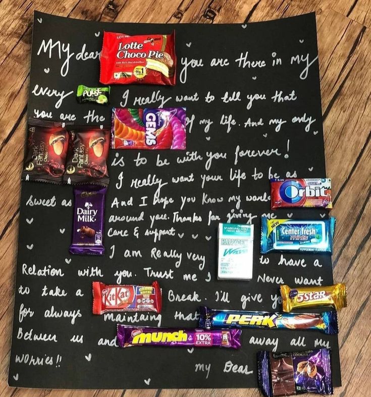 a bulletin board with candy on it and writing on the blackboard next to it