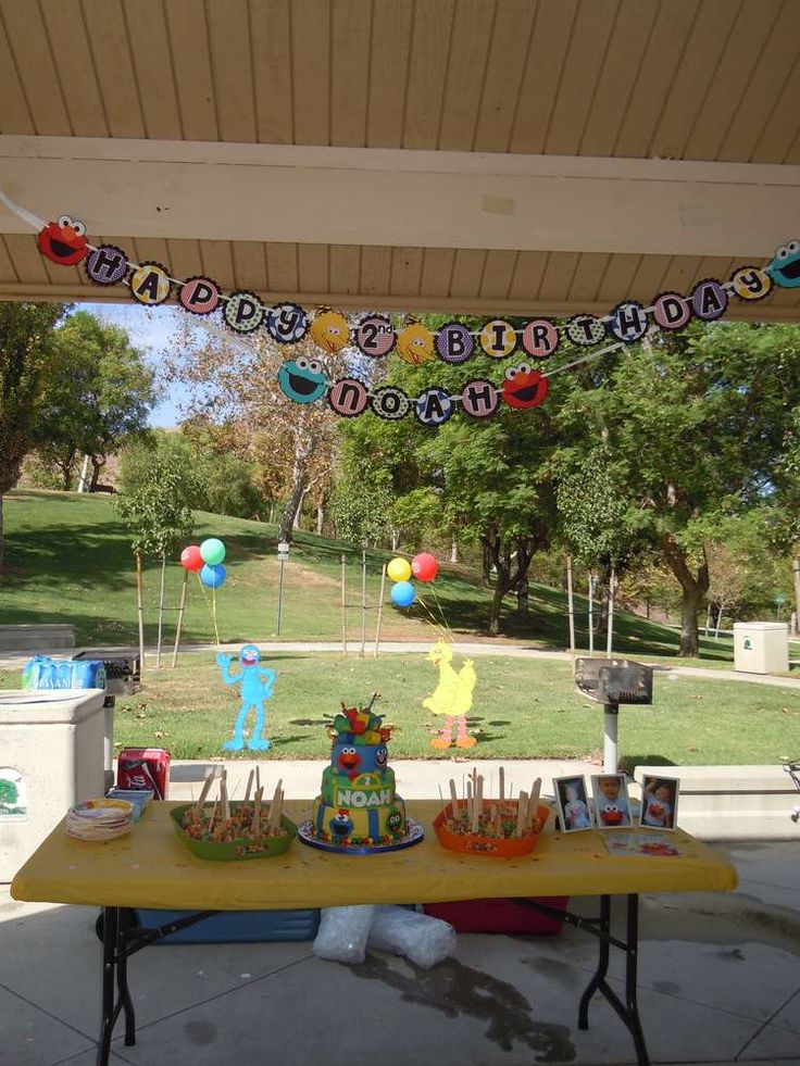 an outdoor birthday party with cake and decorations