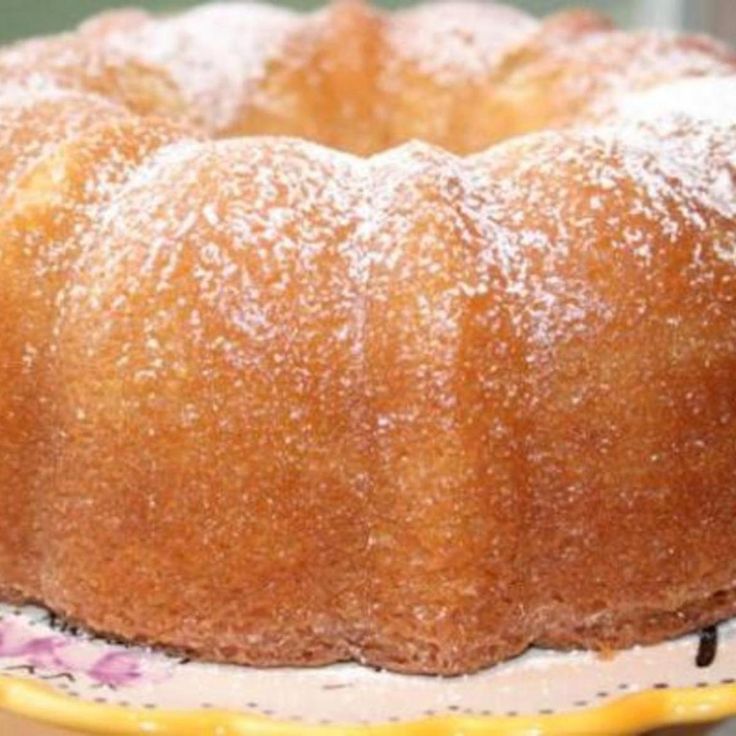 a bundt cake sitting on top of a white plate covered in powdered sugar