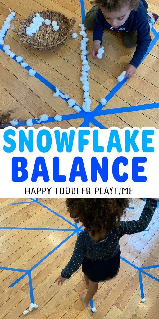 a child playing with snowflake balance on the floor