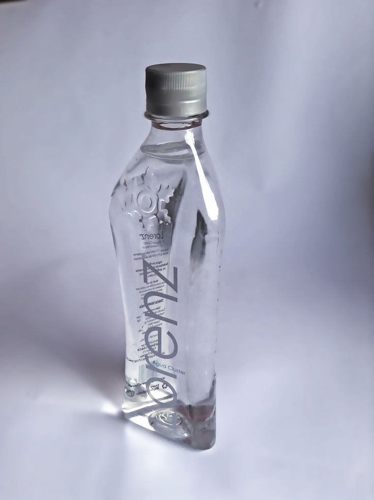 an empty glass bottle sitting on top of a white tableclothed surface with the word zero written on it