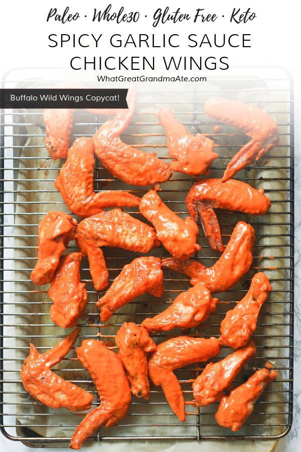 grilled chicken wings on a grill with text overlay that reads, palen gluen - free spicy garlic sauce chicken wings