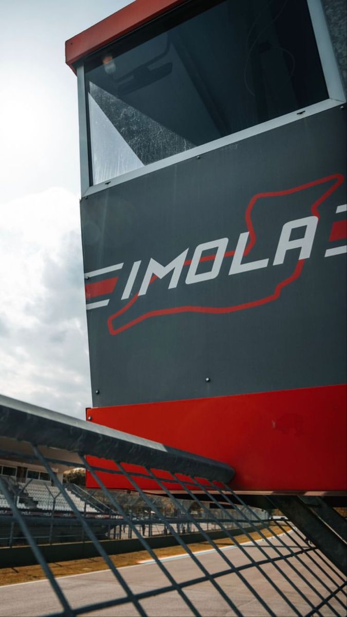 the back end of a red and black boat with an imola logo on it