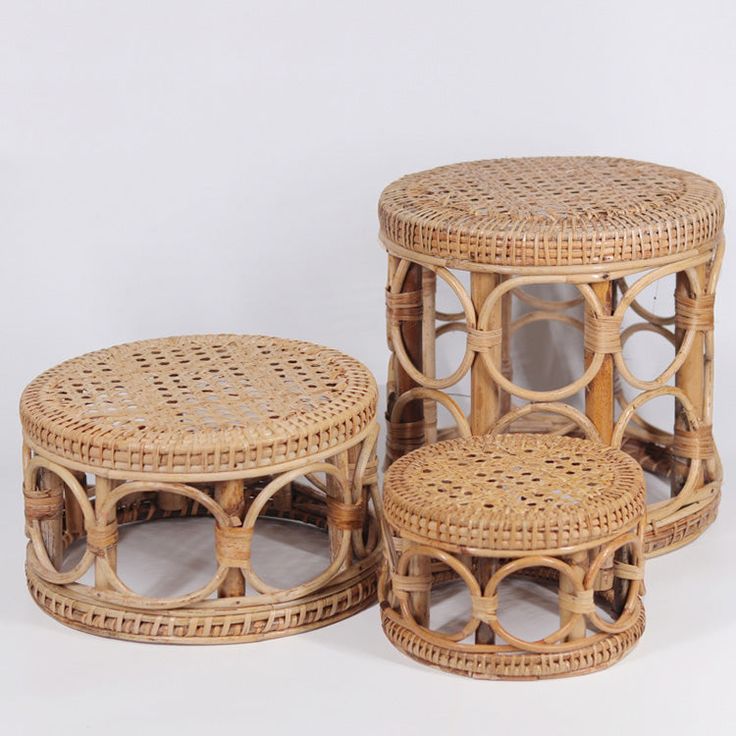 three wicker tables and stools on white background