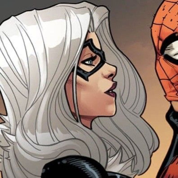 a woman with white hair wearing a spiderman mask next to a man in a black suit