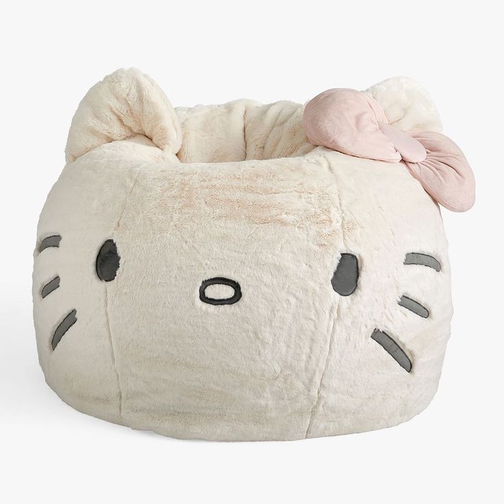 a white hello kitty bean bag with a pink bow on top