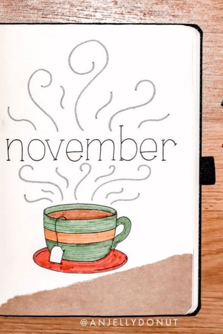 an open notebook with a drawing of a coffee cup and the words november on it