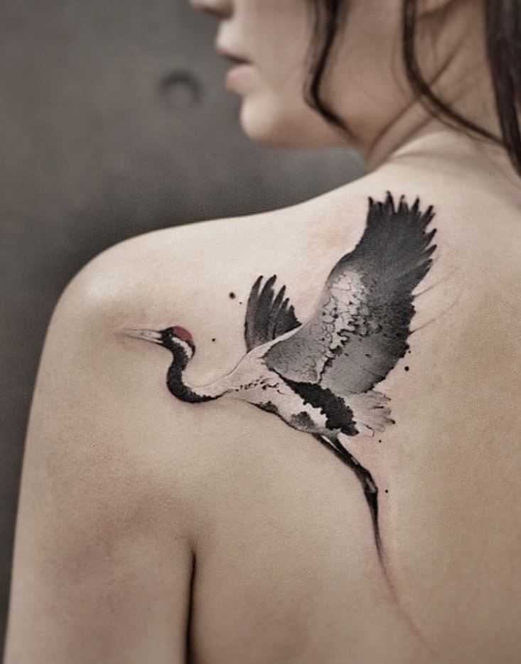 a woman with a bird tattoo on her back